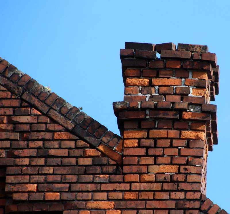 Damaged chimney on an Bell Gardens home showing cracks and missing mortar